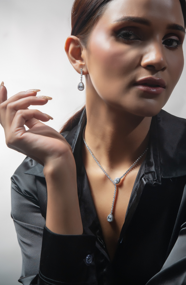 CPS-126 Two pear-shaped pendants with earrings showcase a dangling pear-shaped stone surrounded by a delicate halo