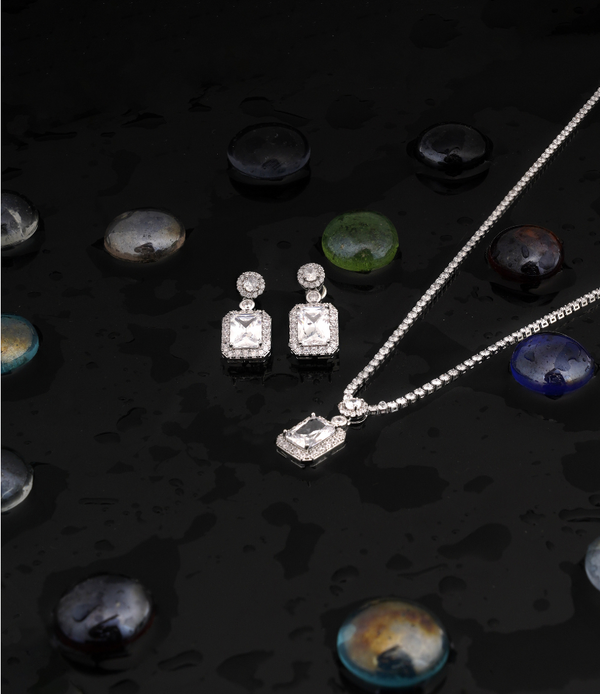 CPS-127 Two pear-shaped pendants with earrings showcase a dangling pear-shaped stone surrounded by a delicate halo